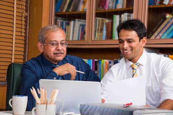 Asian Indian Business People or Corporate culture and Working in the office Concept with Laptop, papers, meetings, presentations and discussions