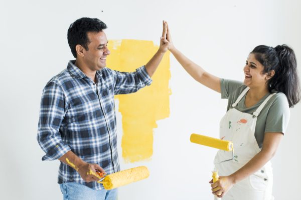 Couple giving a high five while renovating their new house