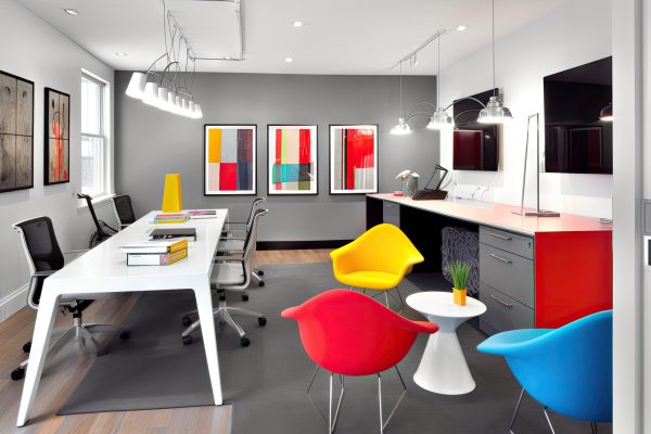 modern workspace with sleek furniture and bold pops of color, created with generative ai